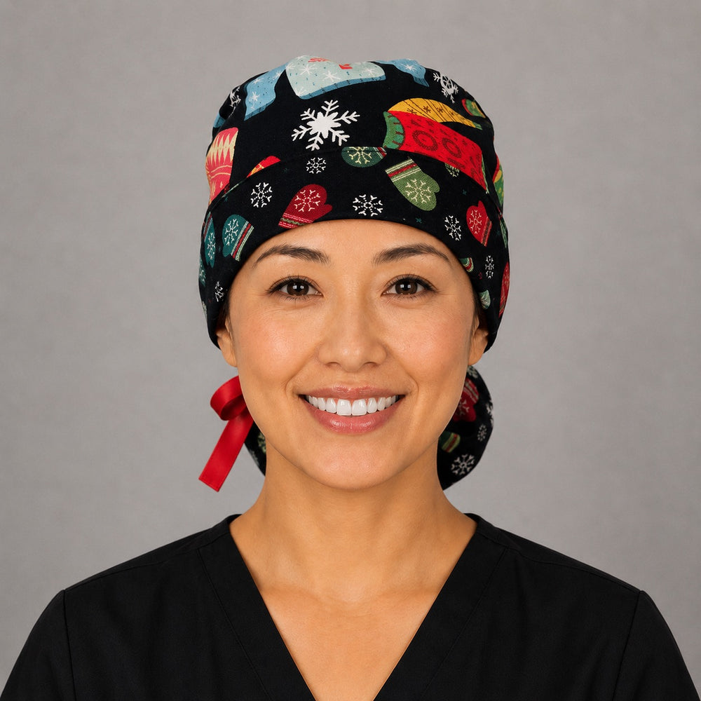 Woman wearing Christmas ugly sweater ponytail scrub cap, front view smiling with festive knit sweaters, mittens and snowflakes on black with red ribbon tie
