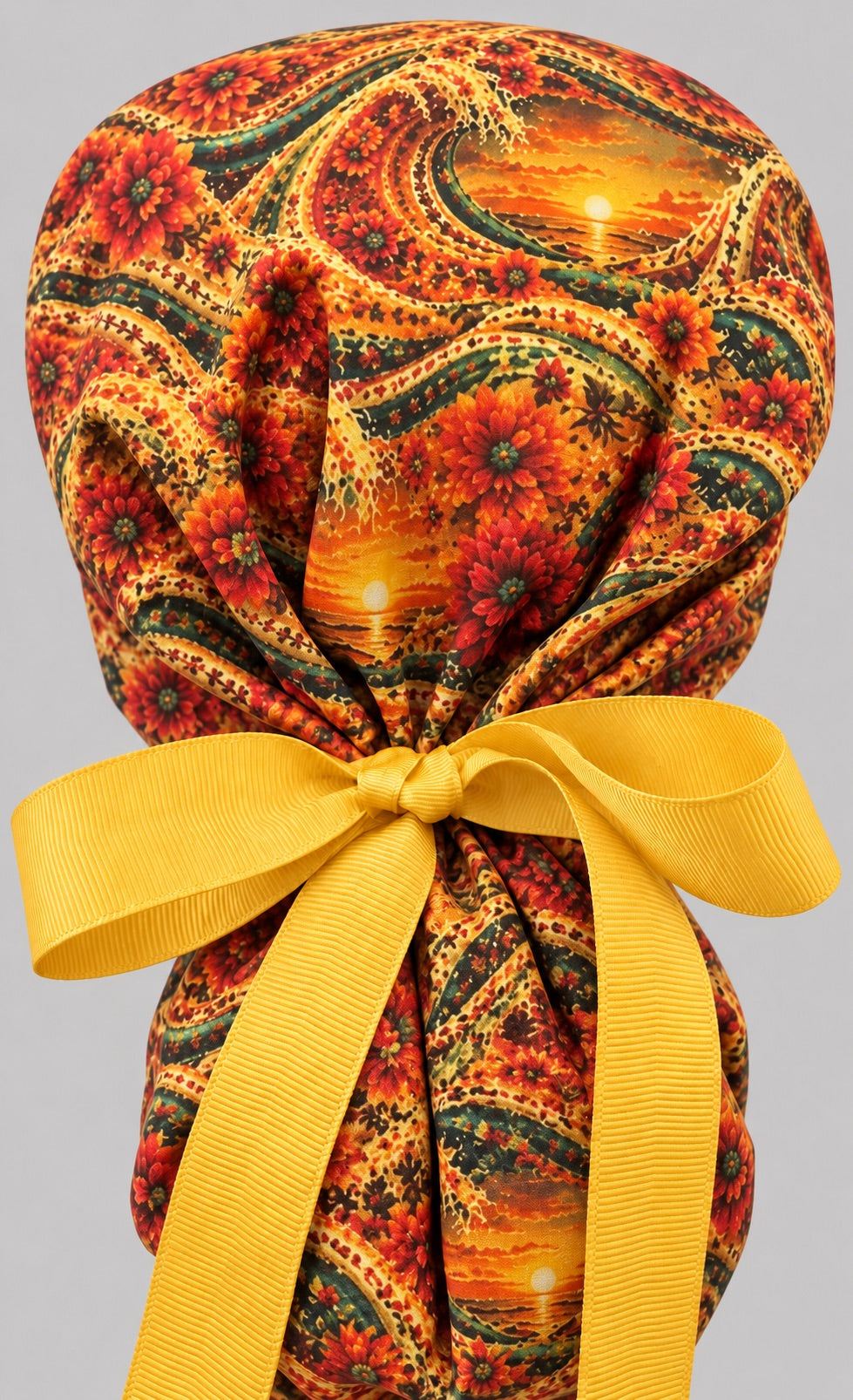 Cinco de Mayo ponytail surgical cap, left side profile — marigold dahlias and sunset print for OR nurses and surgical techs