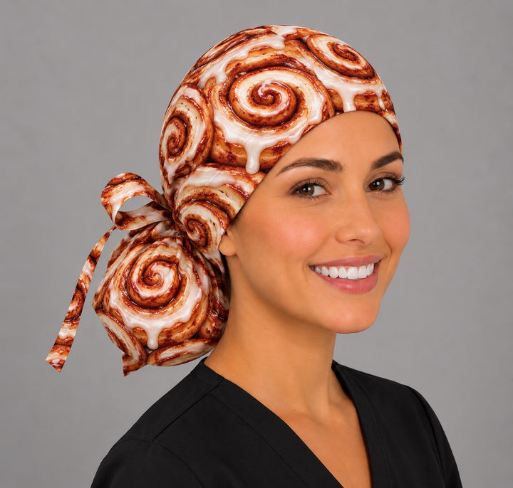 Side view of a cinnamon roll ponytail cap with matching ribbon bow, a sweet scrub cap for scrub techs and CRNAs