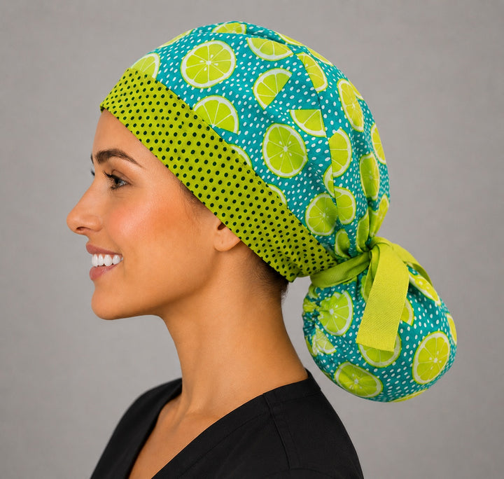 Citrus lemon lime ponytail surgical cap left side profile showing gathered ponytail pouch of lime slices on teal and lime green ribbon tie