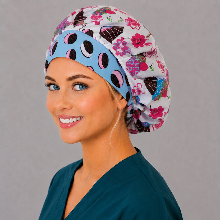 Colorful bakery cupcake bouffant scrub cap angled smiling view — roomy dessert print cap that secures long thick hair