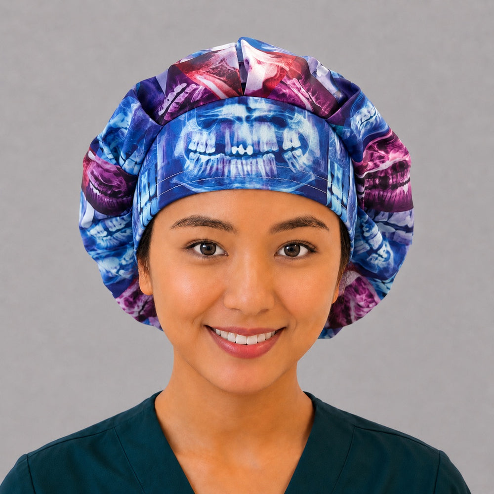 Woman wearing a colorful dental X-ray bouffant scrub cap, front view — vivid blue, red and purple teeth radiograph print, adjustable surgical hat for female dentists