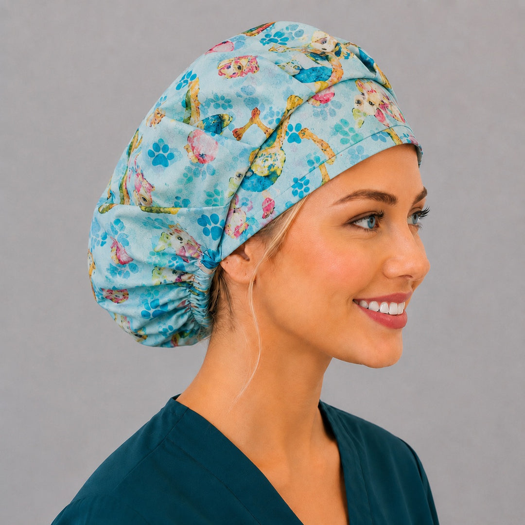 Side profile of the colorful dog bouffant scrub cap — watercolor puppies on a blue paw-print background, roomy cotton surgical cap for vet techs