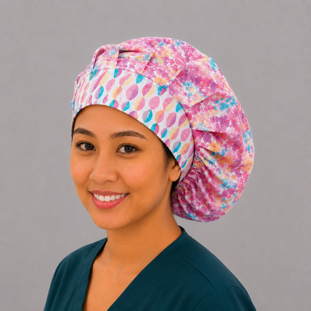 Colorful floral watercolor bouffant scrub cap right side profile showing pink teal orange watercolor florals with geometric accent band, OR World nurse hat