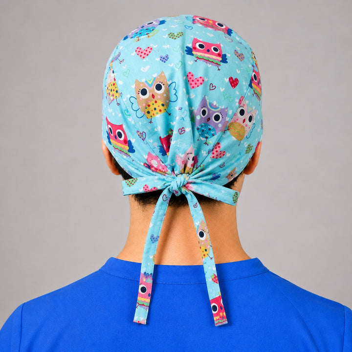 Side profile of colorful owl and heart scrub cap for women with short hair, adjustable OR cap