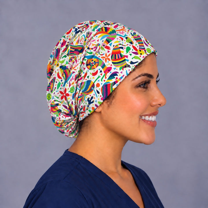 Right profile of a colorful piñata surgical cap, showing the soft gathered elastic at the nape and the full rounded crown behind the ear