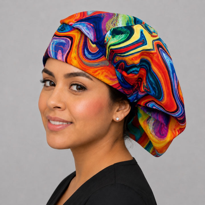 Colorful rainbow swirl bouffant scrub cap for women, bright multicolor pride marble adjustable surgical hat on a smiling nurse, side view