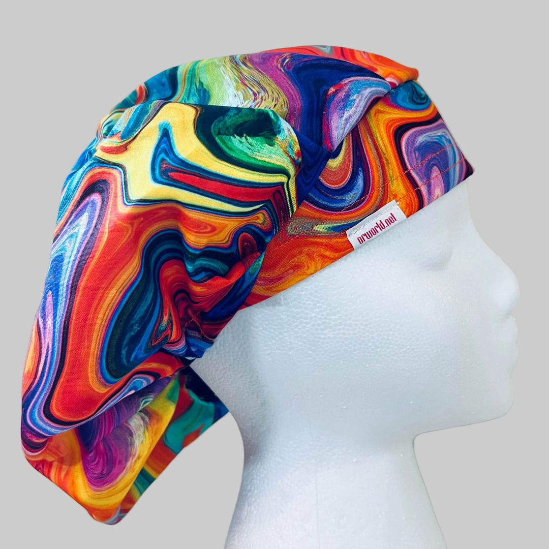 Close-up of colorful rainbow ripple marble fabric — handmade-in-USA OR World bouffant surgical hat for women.