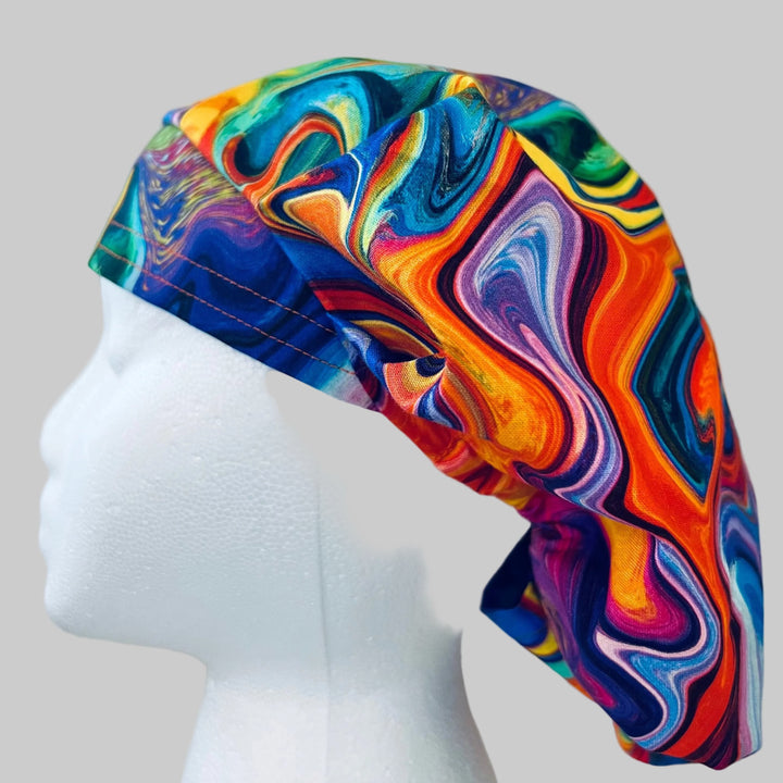 Side view of colorful ripples rainbow bouffant scrub cap — handmade-in-USA surgical hat, vibrant gift for nurses &amp; surgeons.