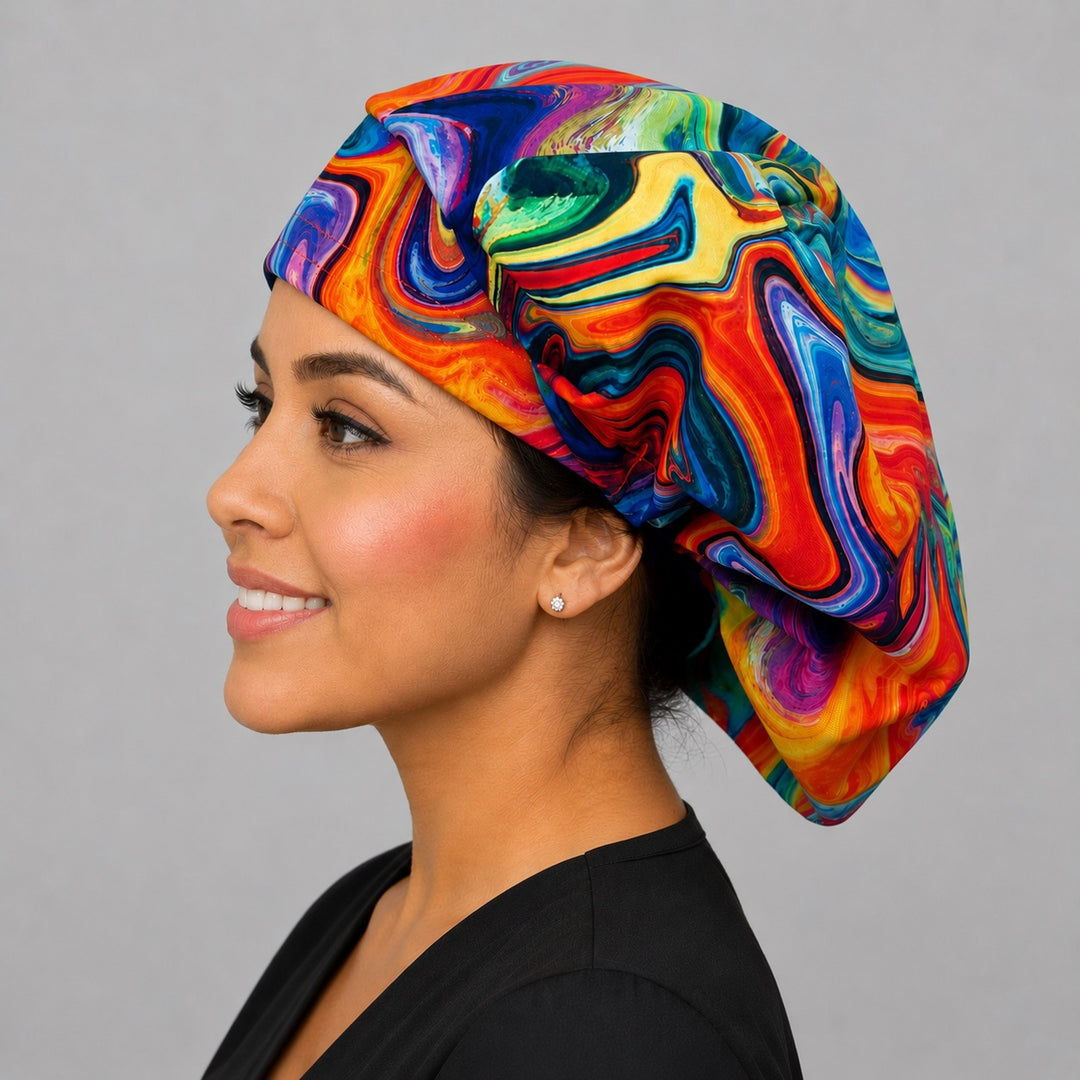 Colorful ripples rainbow bouffant scrub cap left three-quarter angle on smiling model showing swirling rainbow marble print, OR World nurse hat