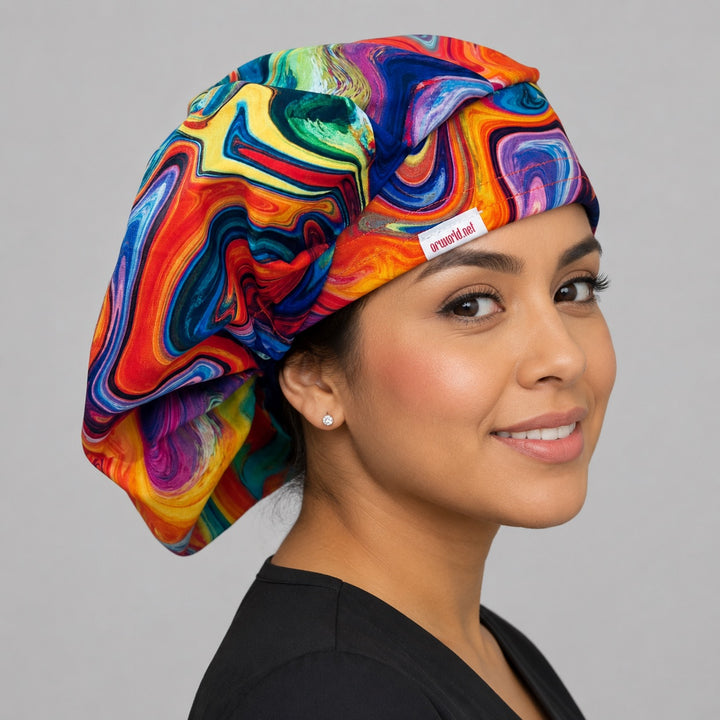 Colorful ripples rainbow bouffant surgical cap right three-quarter angle on smiling model showing swirling rainbow marble print, OR World nurse hat