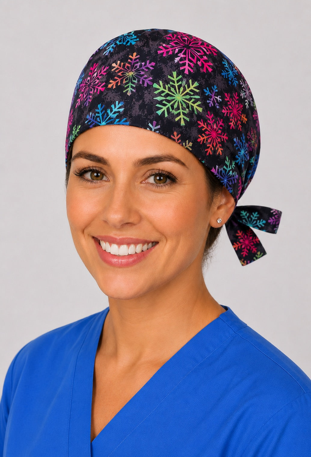Three-quarter view of colorful snowflake unisex black winter adjustable surgical hat for nurses and surgical techs