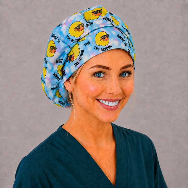 Cool duck bouffant surgical cap for long hair, front angled smiling view — funny sunglasses duck print for OR nurses and surgical techs
