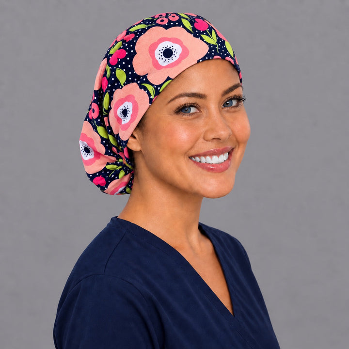 Coral poppy Euro scrub cap, right angled smiling view — peach and pink bloom print for OR nurses and L&amp;D teams
