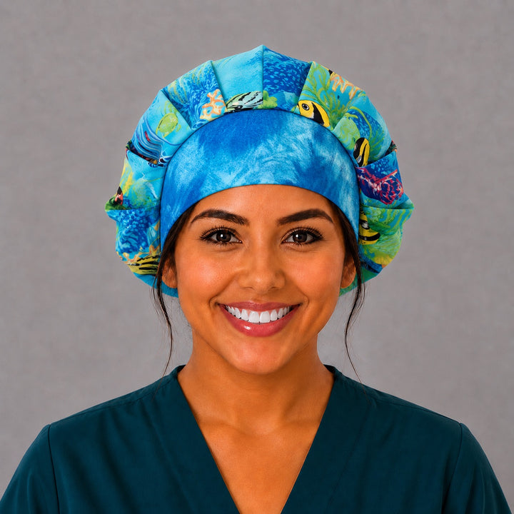 Side view of the coral reef fish bouffant surgical hat — tropical marine life print with ocean-blue band, roomy breathable cotton cap for nurses