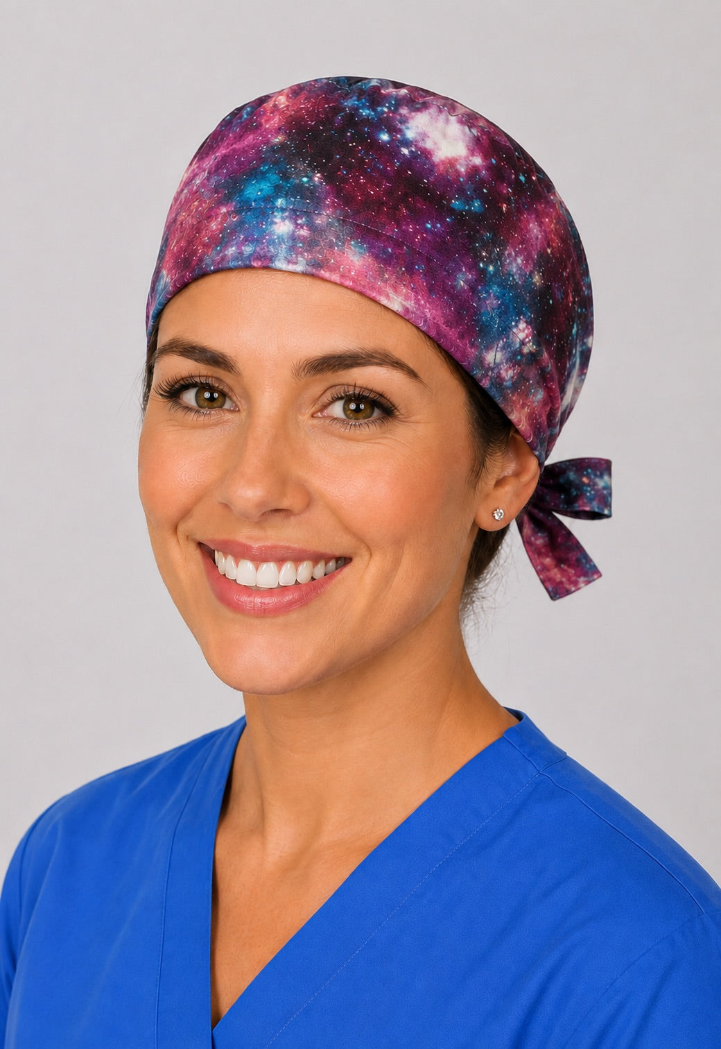 Three-quarter view of cosmic galaxy scrub cap in pink and blue, unisex adjustable surgical hat for nurses and surgical techs