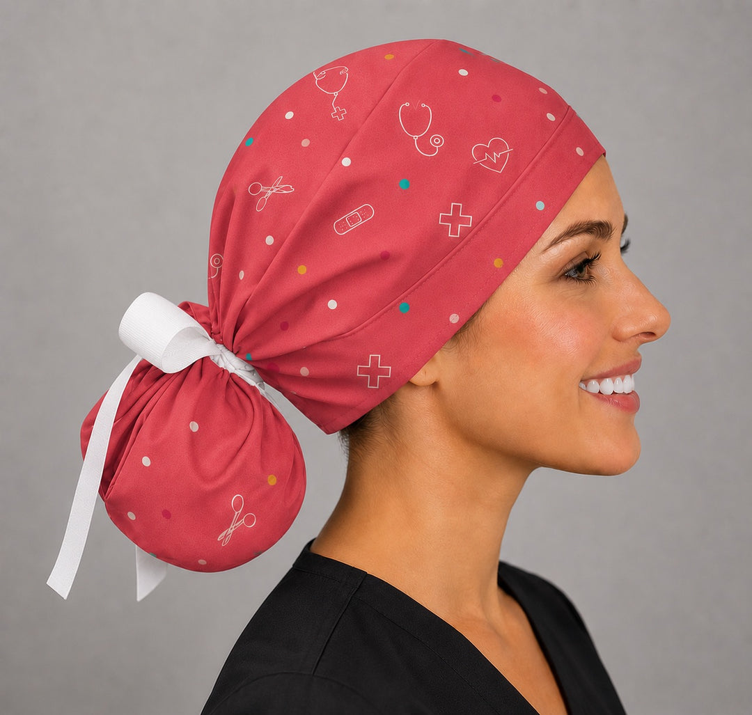 Side view of custom cartoon ponytail scrub cap showing scattered medical symbol print on rose fabric, surgical hat for nurses