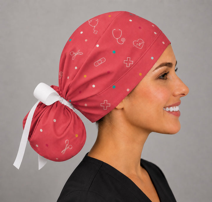 Side view of custom cartoon ponytail scrub cap showing scattered medical symbol print on rose fabric, surgical hat for nurses