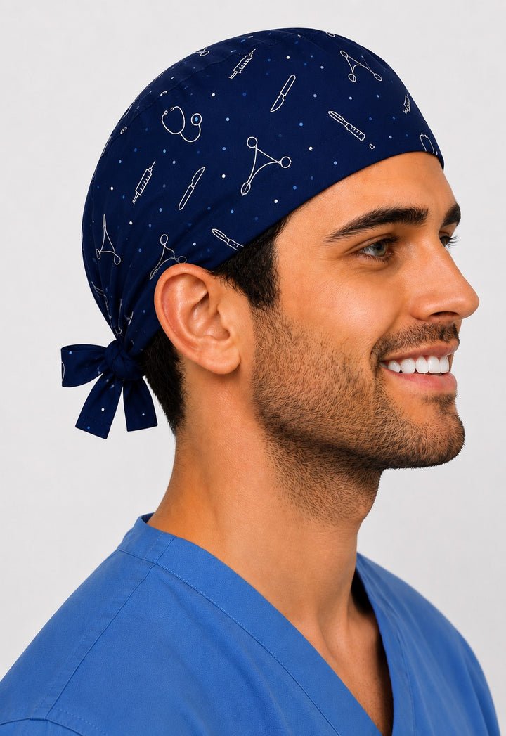 Side profile of a navy custom photo cartoon tie-back scrub cap with scattered white medical line-art icons like scalpel, syringe and stethoscope, personalized men&