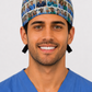 Smiling male surgeon wearing a custom photo grid scrub cap covered in healthcare team photos, front view — personalized photo surgical hat, handmade in the USA by OR World.