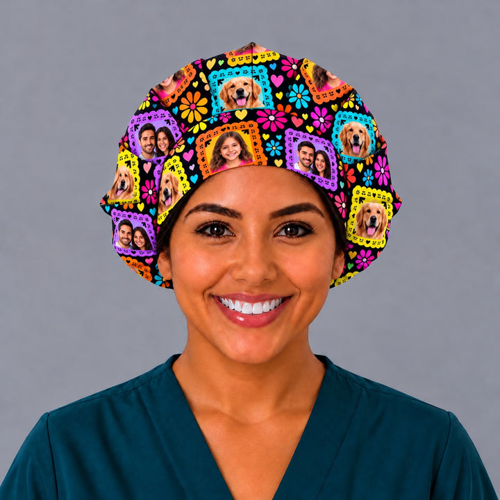 Smiling nurse in teal scrubs wearing a custom photo papel picado bouffant scrub cap, front view with family, child and golden retriever photo frames across the band