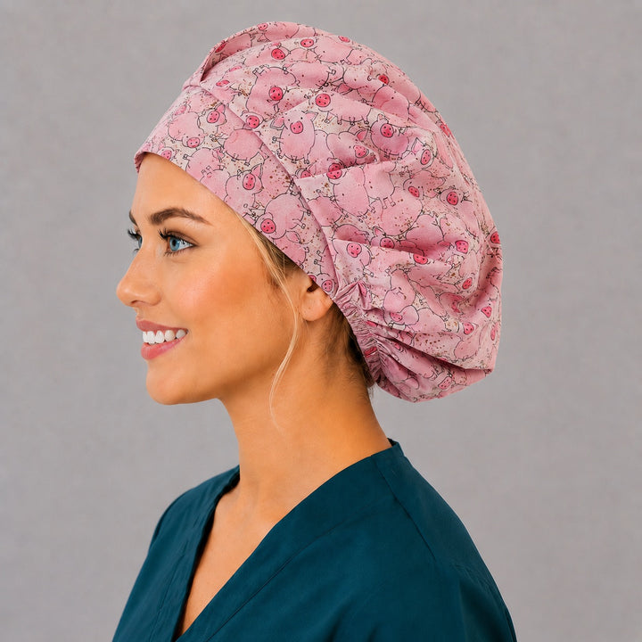 Left side profile of the cute piglet bouffant surgical hat — hand-drawn pigs with curly tails, roomy breathable cotton cap for nurses