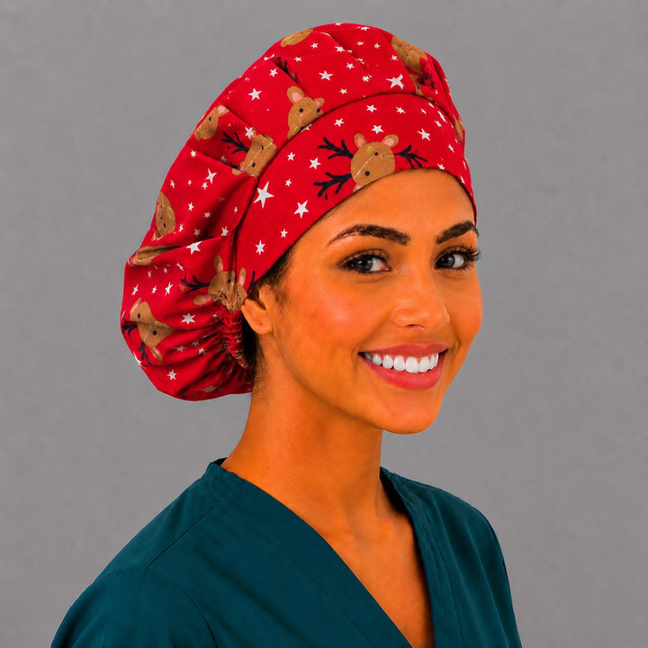 Cute reindeer Christmas bouffant cap for women, angled smiling view — handmade festive red surgical cap, USA made