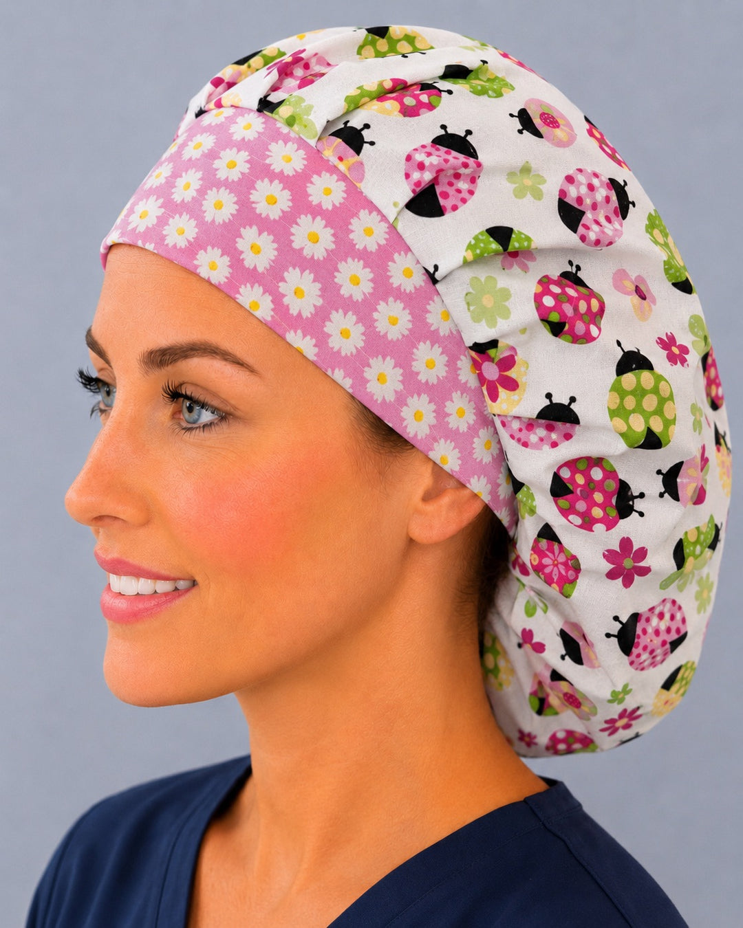 Daisy band ladybug bouffant scrub cap angled smiling view — spring floral print bouffant hat for OR nurses and surgical techs