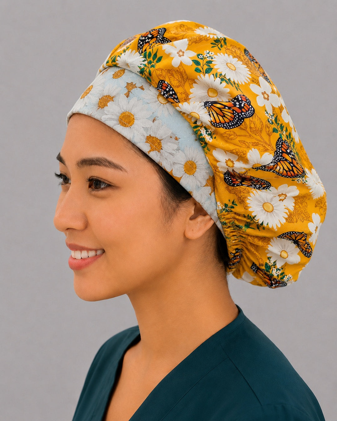 Left side profile of the daisy and butterfly bouffant surgical hat — white daisy contrast band with golden floral crown, roomy breathable cotton cap