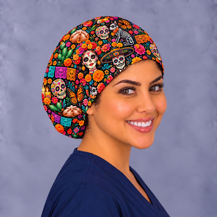 Right angle view of a Day of the Dead Euro scrub cap showing a Xoloitzcuintle, veladora candles, nopal cactus and papel picado on black, handmade in the USA by OR World