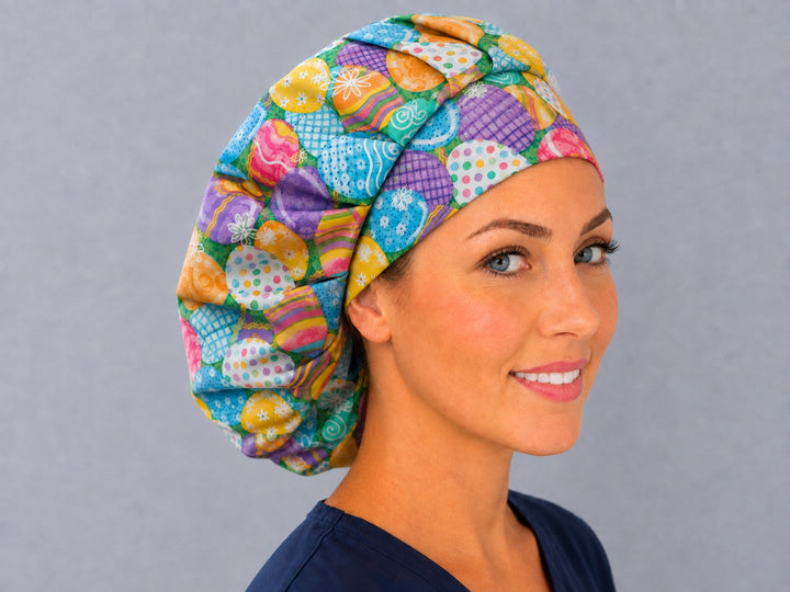 Decorated Easter egg bouffant scrub cap, right angled smiling view — plaid, chevron and daisy eggs for OR nurses and surgical techs