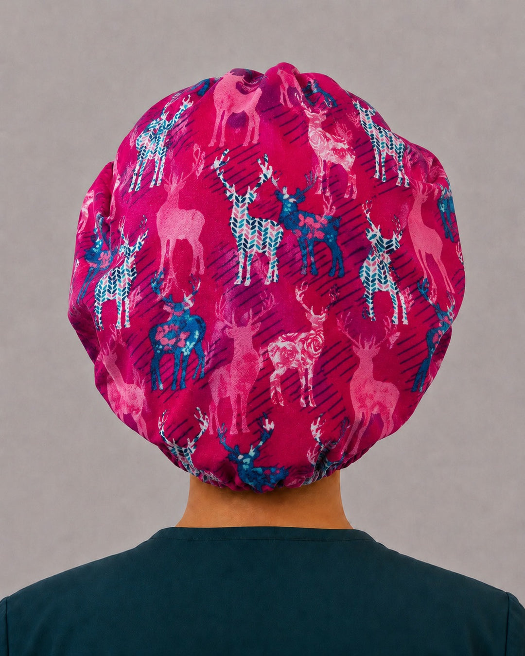 Back view of the deer bouffant scrub cap — full gathered fit showing blush, teal and navy stags across the berry pink crown