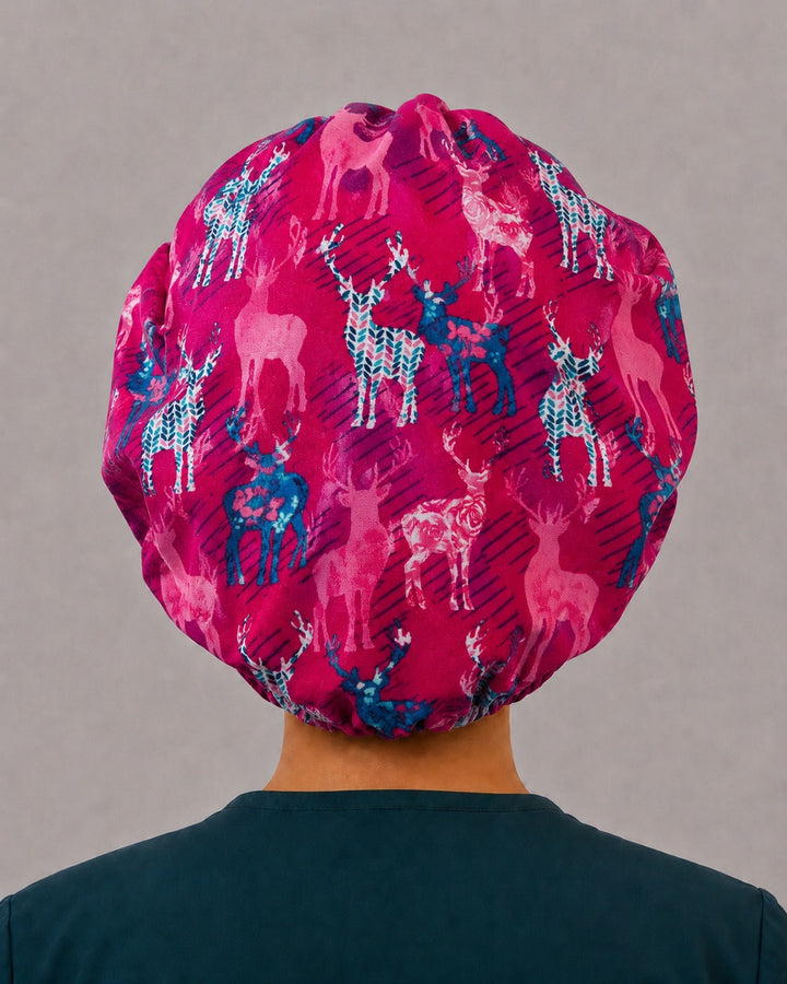 Back view of the deer bouffant scrub cap — full gathered fit showing blush, teal and navy stags across the berry pink crown