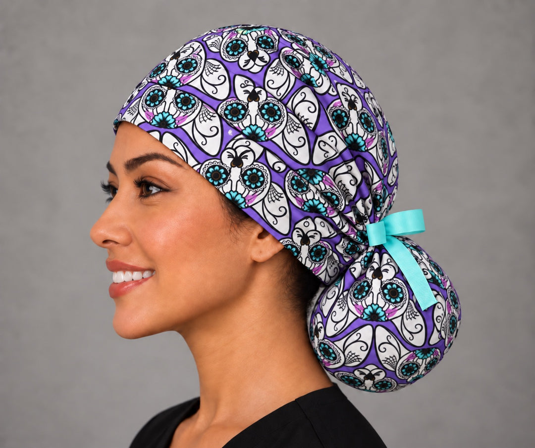 Día de los Muertos cat ponytail cap, left side profile — aqua grosgrain bow and roomy bun pouch, handmade in the USA