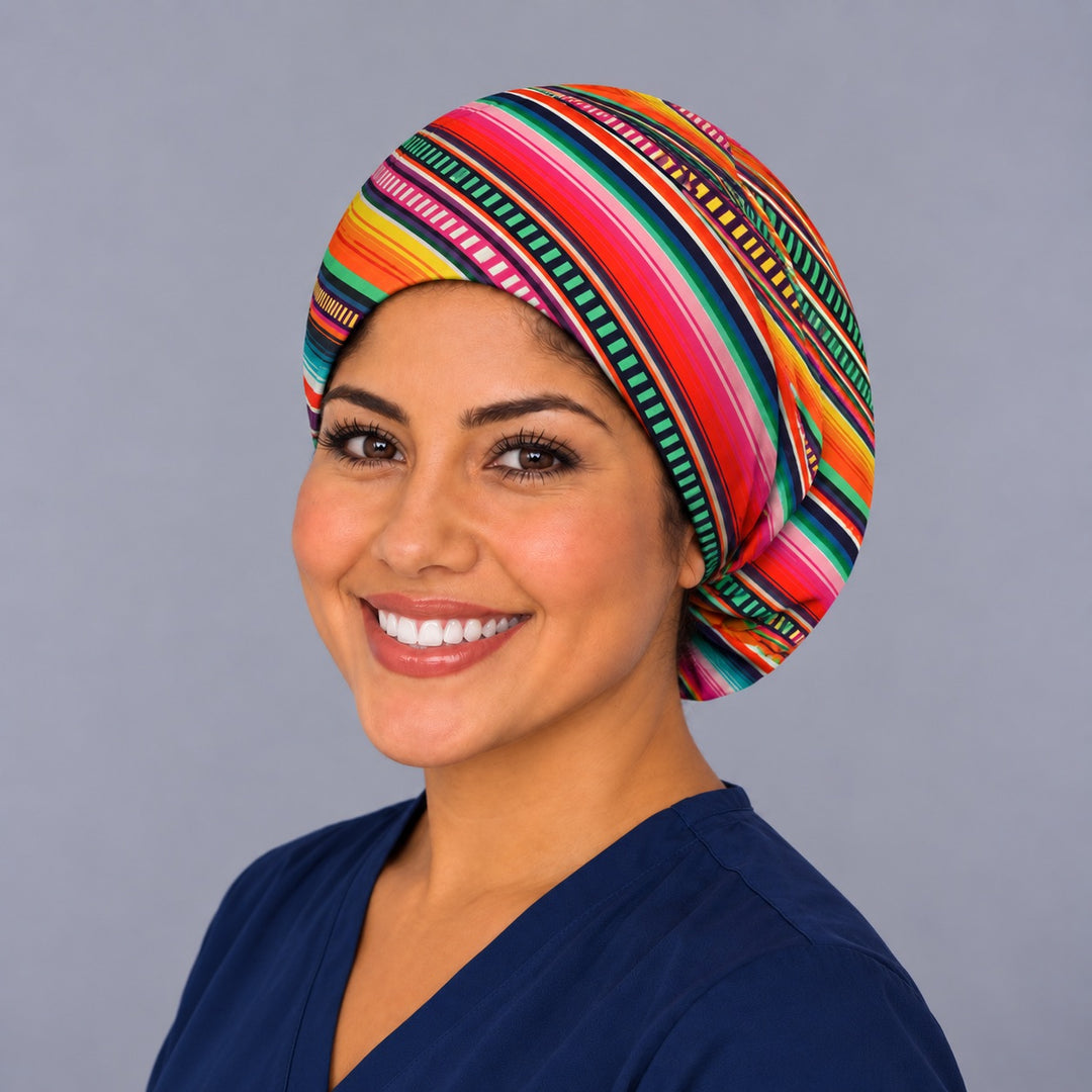 Diagonal Mexican blanket bouffant scrub cap, left three-quarter view, sarape stripe surgical hat for women in pink, orange and turquoise