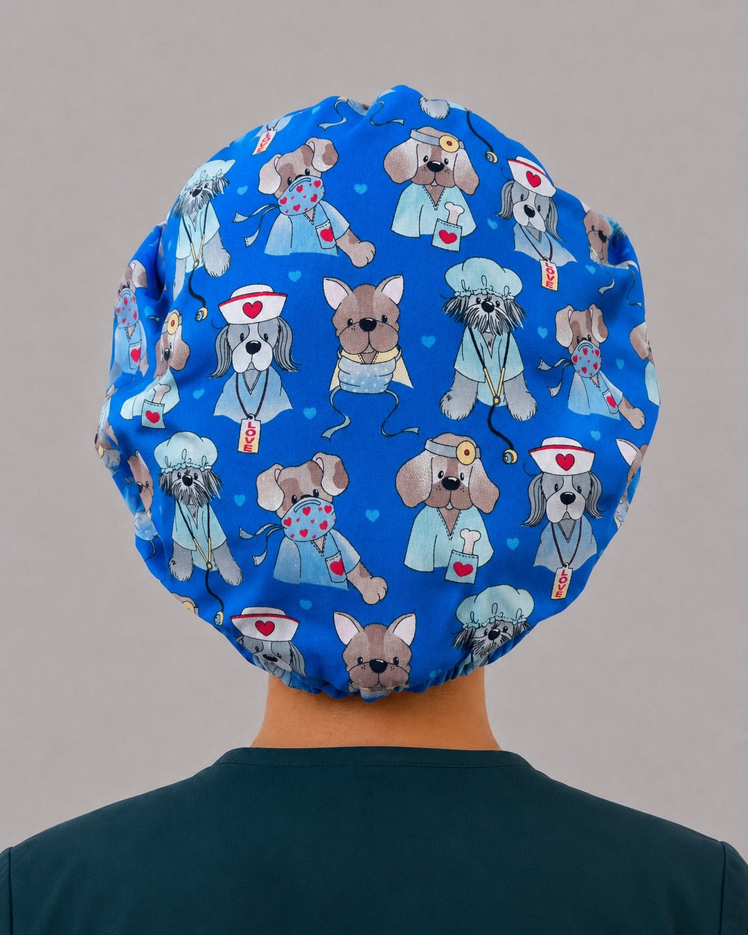Back view of the dog nurses bouffant scrub cap — full roomy fit showing dogs in scrubs, masks and LOVE badges on royal blue