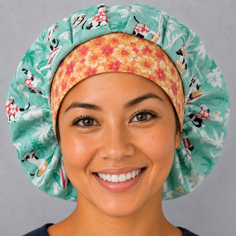 Woman wearing a dog surfing bouffant scrub cap, front view — surfing pups on seafoam teal with orange hibiscus band, adjustable women's surgical hat