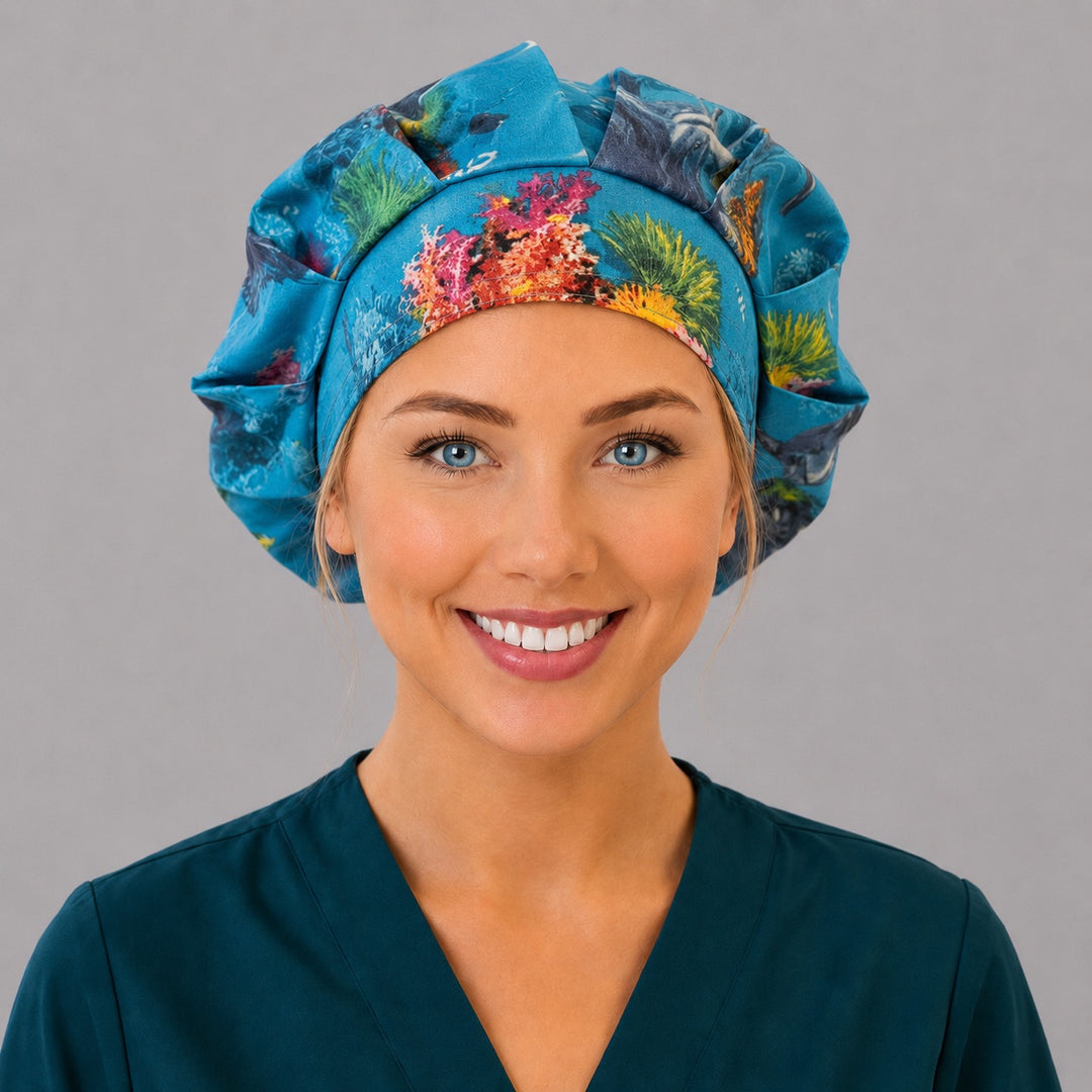 Woman wearing a dolphin ocean bouffant scrub cap, front view — dolphins and coral reef on deep blue, adjustable women's surgical hat