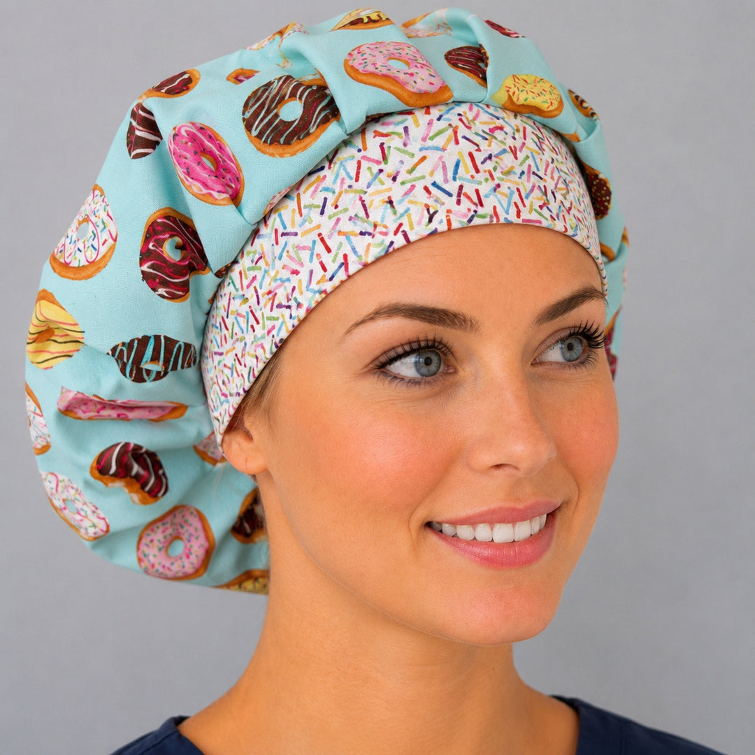 Woman wearing a donut bouffant scrub cap, front view — frosted doughnuts on aqua with white sprinkles band, adjustable women's surgical hat