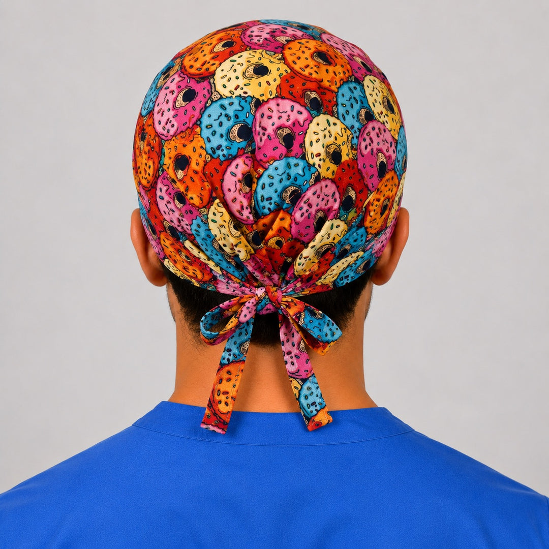 Back view of the colorful donut print tie-back scrub cap showing the bow tie closure and full sprinkle donut print