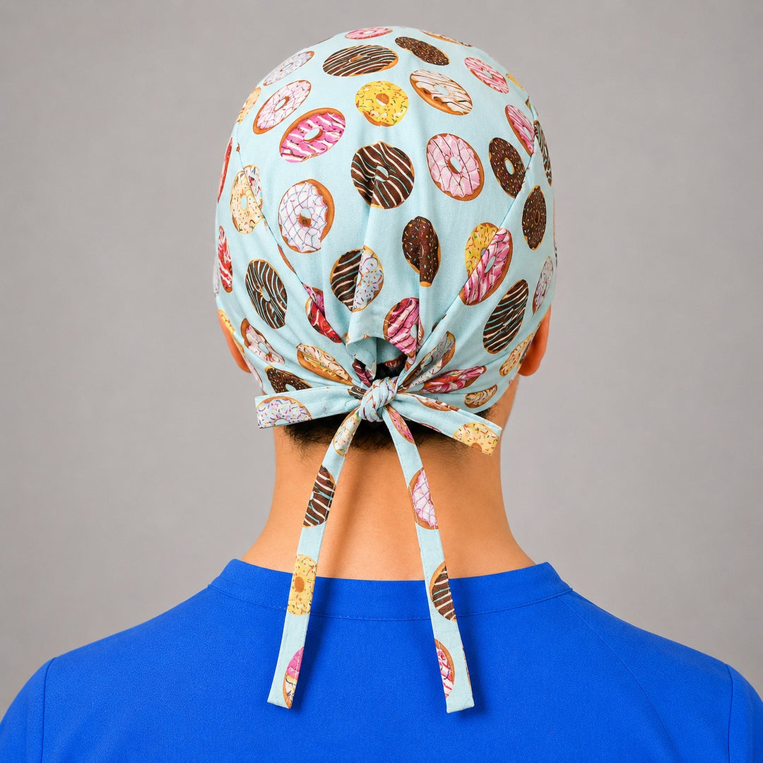 Donut scrub cap for short hair, handmade mint tie-back surgical hat with frosted doughnuts on OR nurse, front view