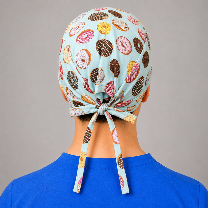 Donut scrub cap for short hair, handmade mint tie-back surgical hat with frosted doughnuts on OR nurse, front view