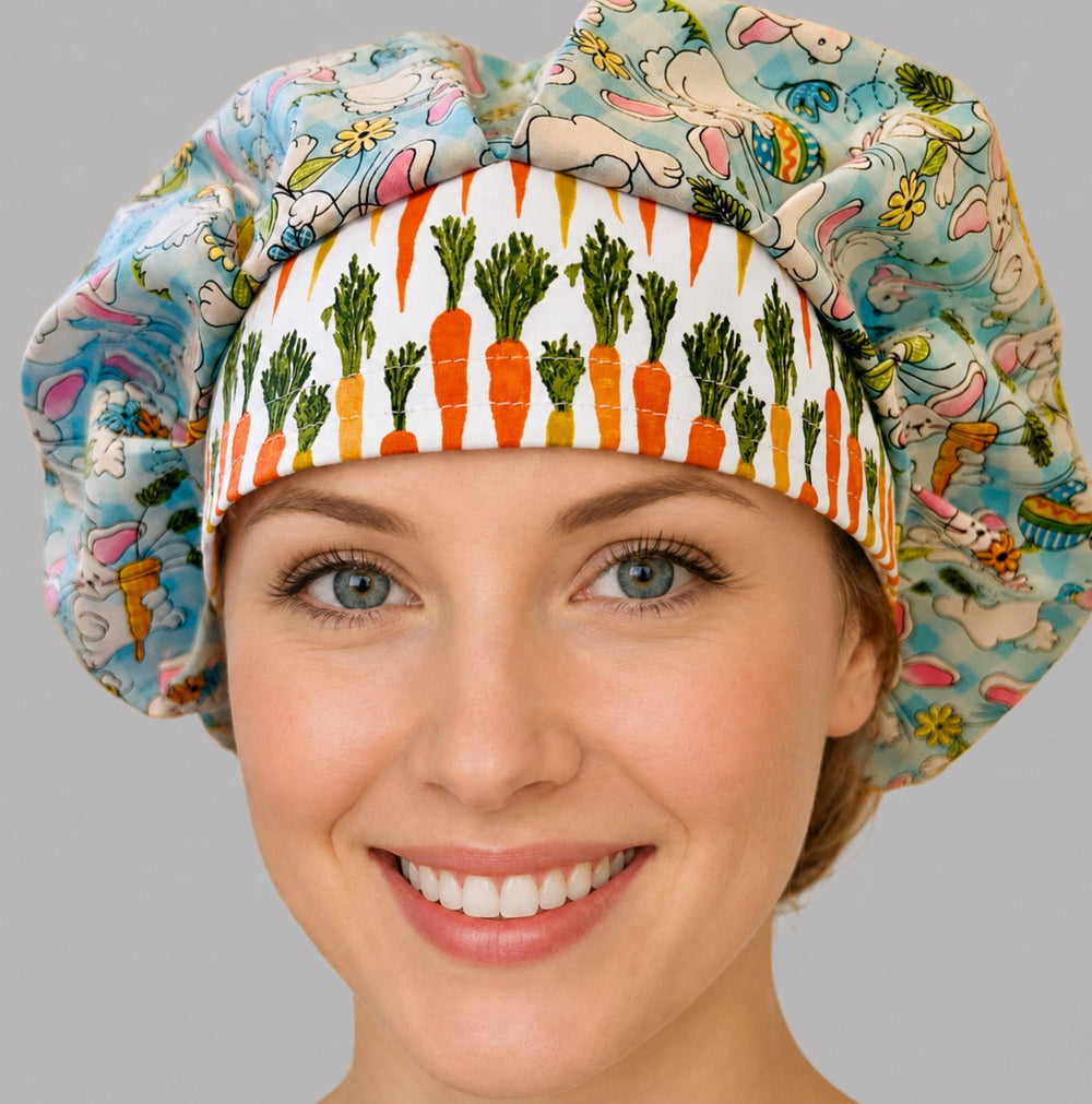 Woman wearing an Easter rabbit bouffant scrub cap, front view — white bunnies with carrots on aqua gingham with an orange carrot band, adjustable women's surgical hat