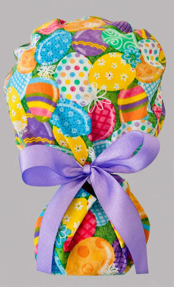 Easter colorful eggs ponytail scrub cap back view close-up showing gathered pouch full of vibrant decorated Easter eggs with lavender grosgrain ribbon bow