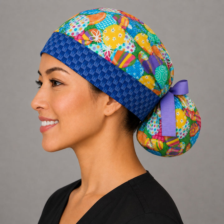 Easter colorful eggs ponytail scrub cap left side view on smiling model showing blue bunny band close-up with vibrant decorated eggs and lavender ribbon