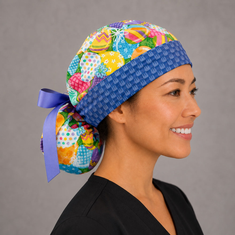 Easter colorful eggs ponytail scrub cap left side profile showing gathered ponytail pouch of vibrant decorated eggs with blue bunny band and lavender ribbon tie