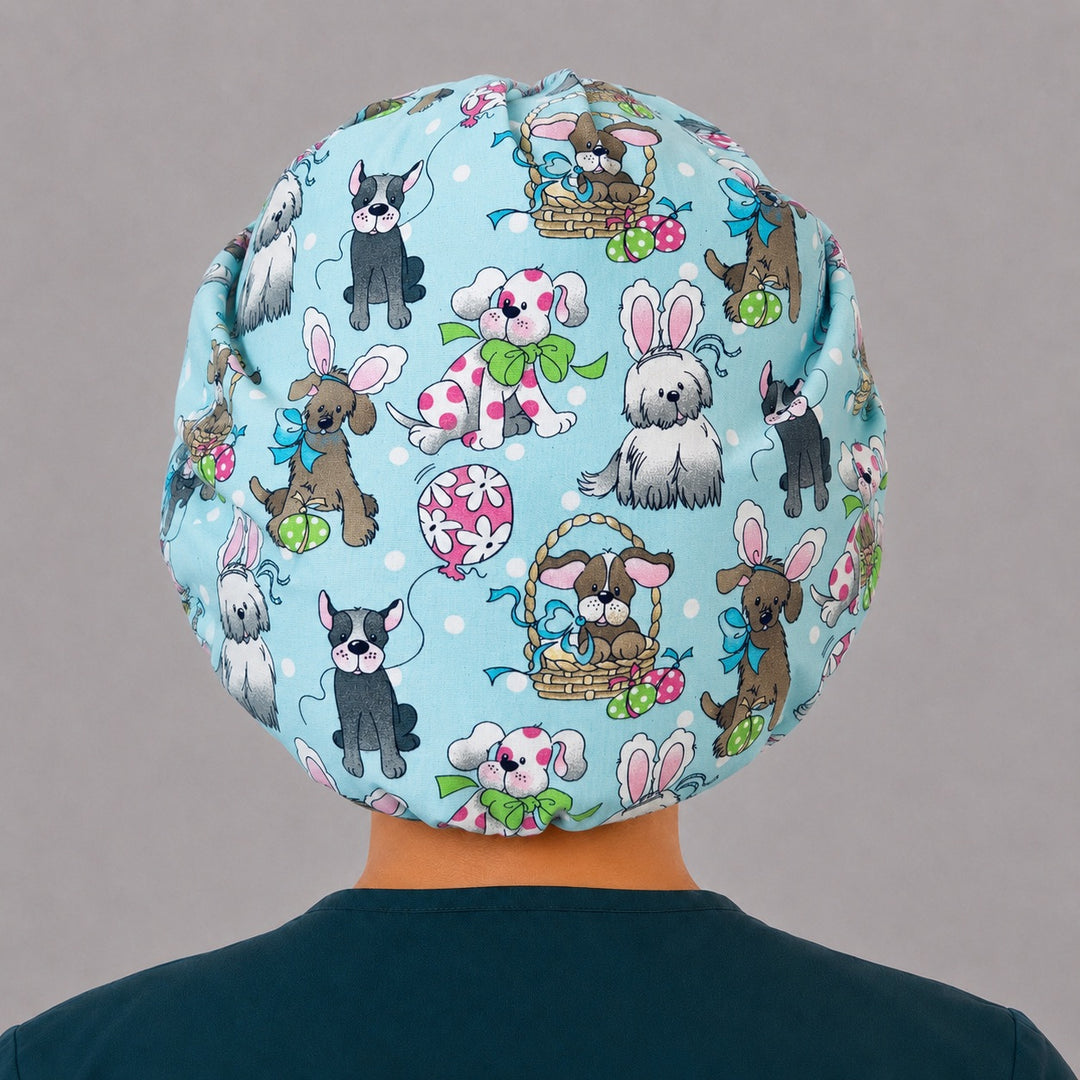 Side view of the Easter dog bouffant surgical hat — puppies with bunny ears, Easter eggs and hot-pink polka-dot band, roomy cotton cap for nurses