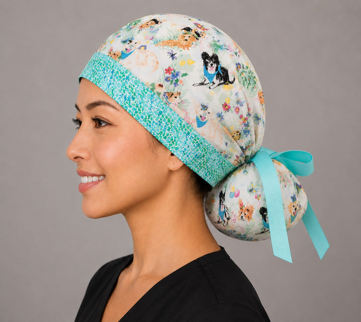 Easter dog ponytail surgical cap left side profile showing gathered ponytail pouch of bunny-ear puppies and Easter flowers with aqua ribbon tie
