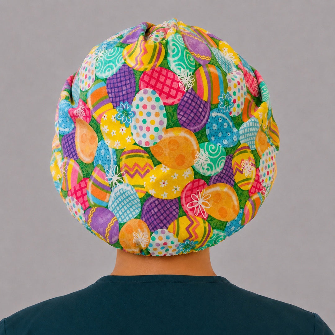 Back view of the Easter egg bouffant scrub cap — full gathered fit showing decorated eggs across the spring green crown