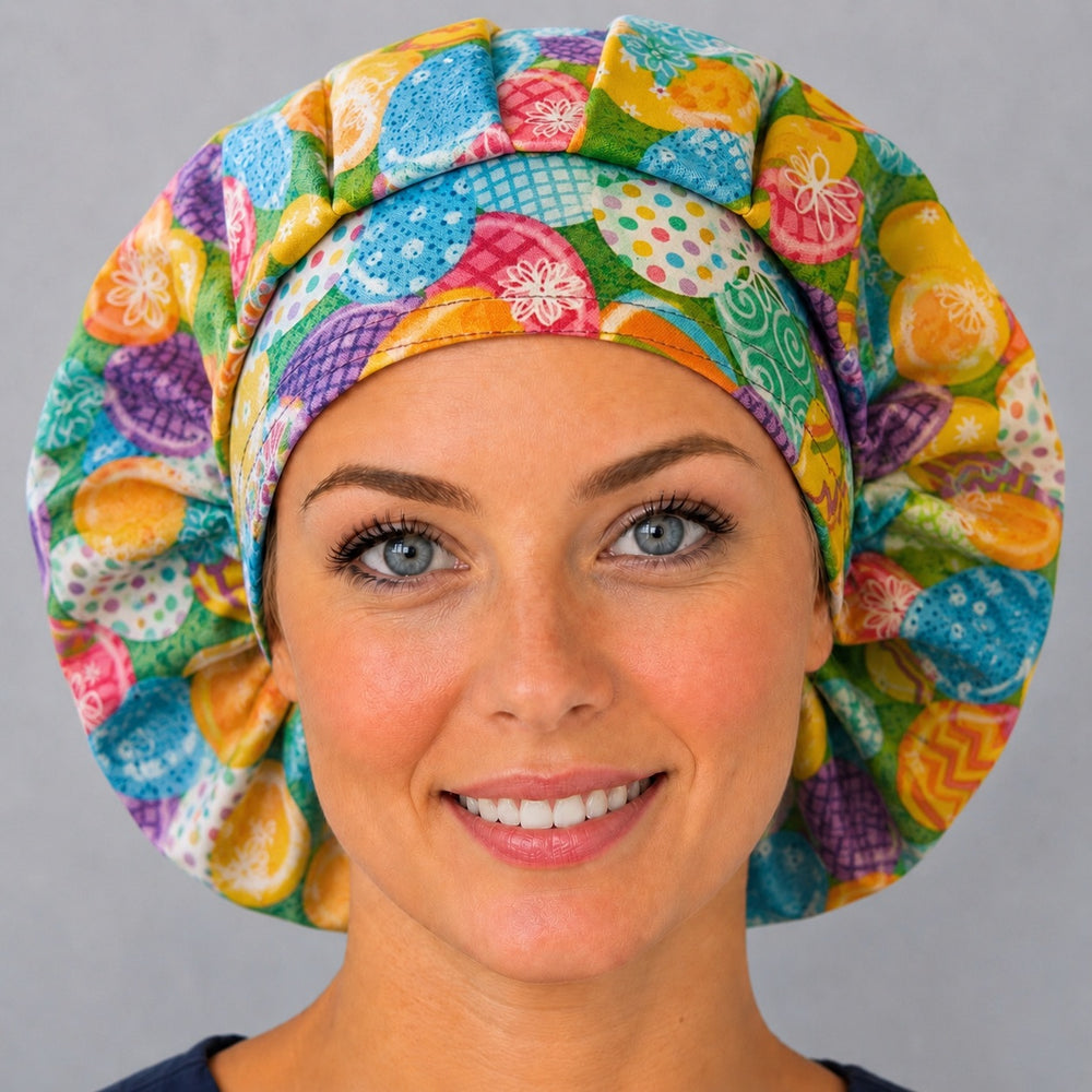 Woman wearing an Easter egg bouffant scrub cap, front view — decorated eggs on spring green, adjustable women's surgical hat
